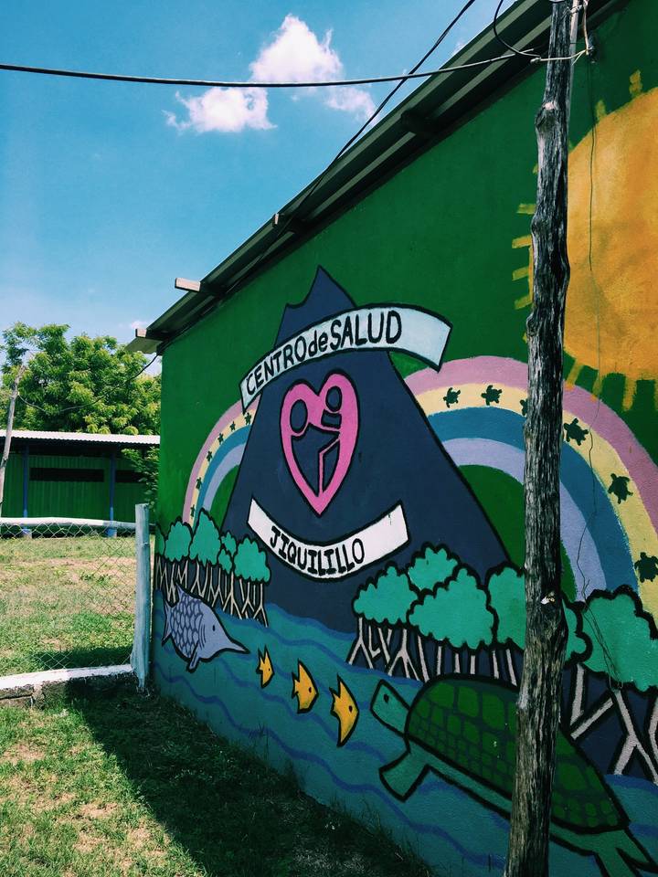 Colorful mural on a green wall of a health center.