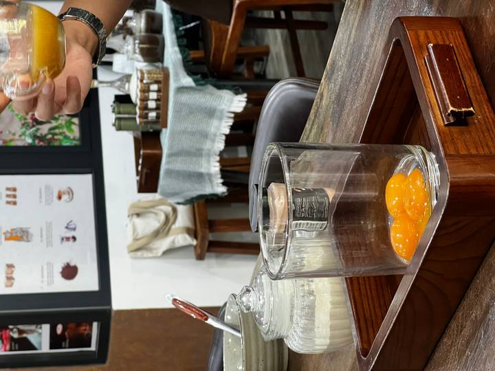 Glass containing raw egg yolks ready for making traditional Vietnamese egg coffee during a workshop.