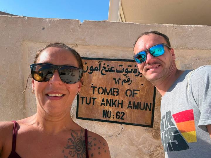 Couple taking selfie beside the sign for Tomb of Tutankhamun No. 62.