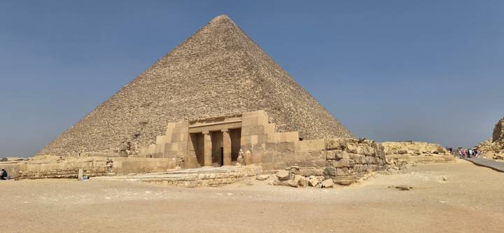 Great Pyramid of Giza rising above sandy plateau under cloudless sky