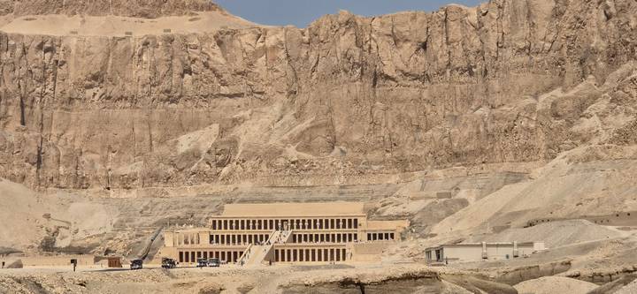 Temple of Hatshepsut nestled beneath towering limestone cliffs in the Theban hills