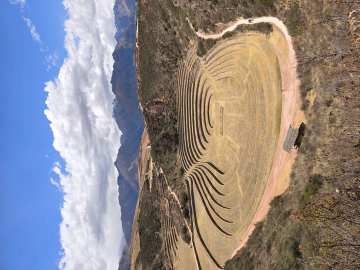 Circular agricultural terraces of Moray set against a dramatic Andean backdrop