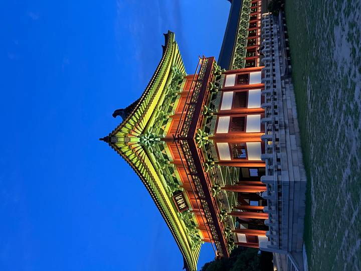 Elegant traditional pavilion in Gyeongju brilliantly lit against a deep blue twilight sky.