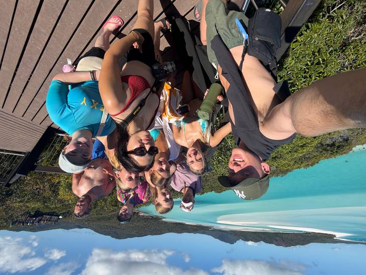 Selfie of travellers at a lookout over Hill Inlet’s swirling turquoise waters in the Whitsundays.
