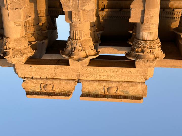 Sun-lit columns and hieroglyphs of Kom Ombo Temple glowing in warm afternoon light.