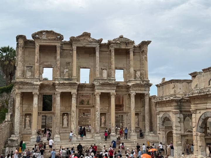 Grand façade of the Library of Celsus in Ephesus with tourists below