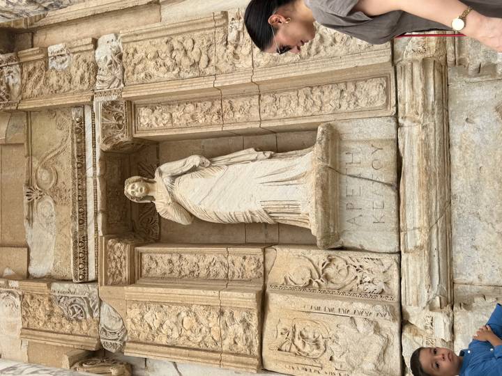Marble statue of Arete among ornate niches at Ephesus Library of Celsus