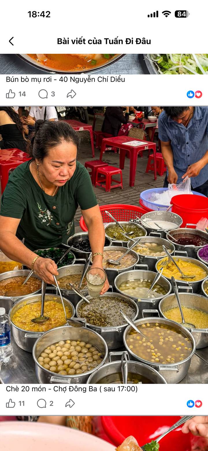 Street vendor scooping colourful Vietnamese desserts from metal pots at an outdoor stall.