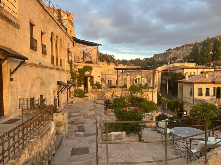 Stone cave-style hotel terraces in Cappadocia at dusk with warm lighting