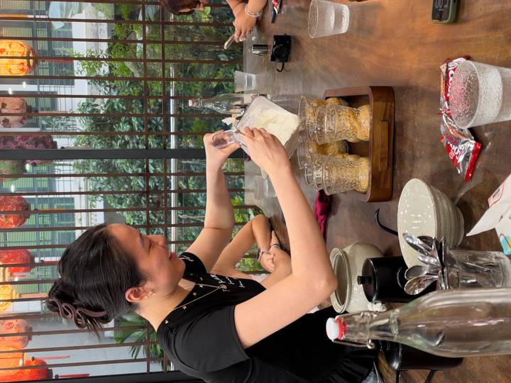 Instructor prepares Vietnamese egg coffee at a wooden table during a workshop