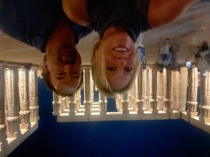 Couple’s night-time selfie in front of the grand colonnade of Luxor Temple lit by warm lights.