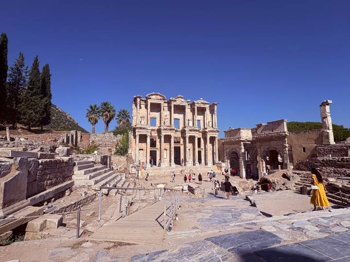ancient Library of Celsus ruins in Ephesus with tourists exploring under clear sky