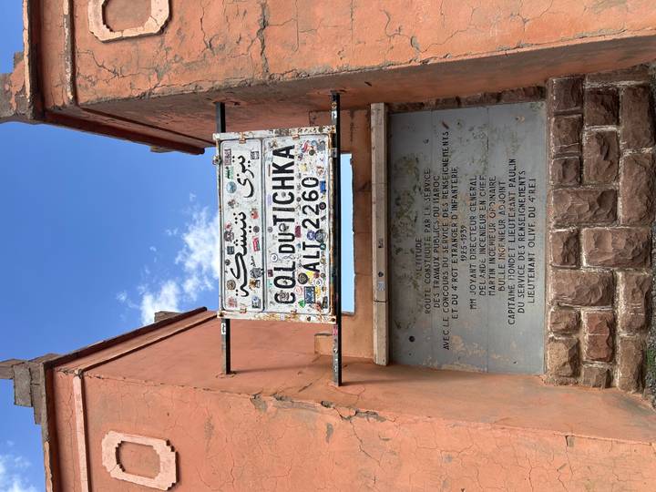 A weathered roadside sign marks Col du Tichka mountain pass at 2,260 meters.