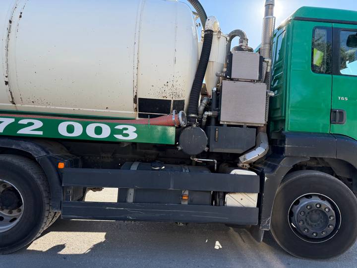 Close-up of industrial green truck tank and mechanical parts.