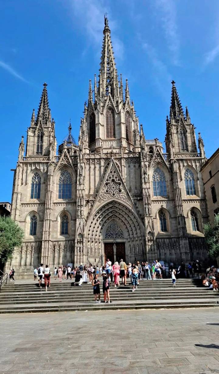 Gothic cathedral facade with ornate spires and large arched entrance.
