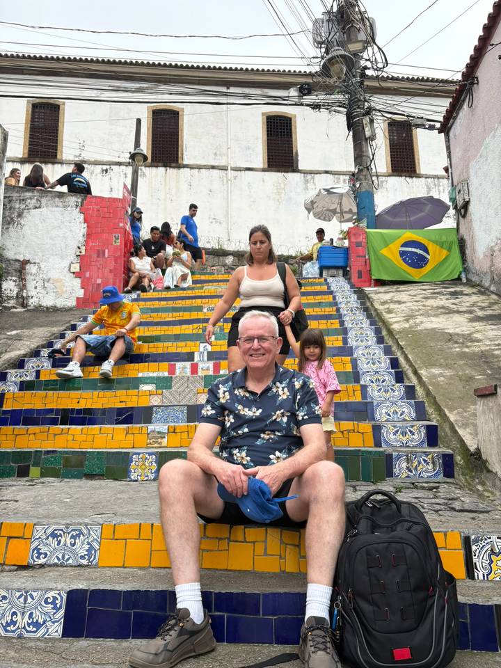 Tourists sit and pose on the colourful Escadaria Selarón mosaic steps in Rio.