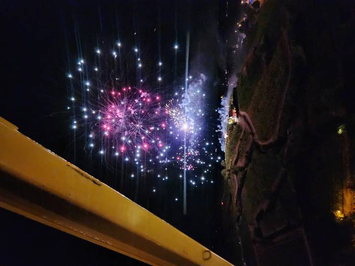 Colorful fireworks bursting in the night sky viewed from an elevated vantage.