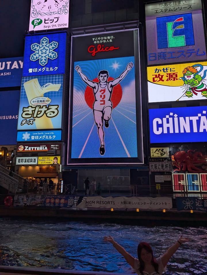 Night view of neon billboards in a bustling entertainment district featuring the famous running man sign