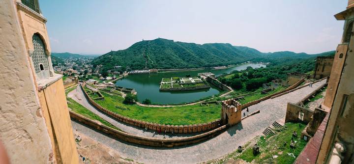 Sweeping aerial view from Amber Fort over Maota Lake and green Aravalli hills
