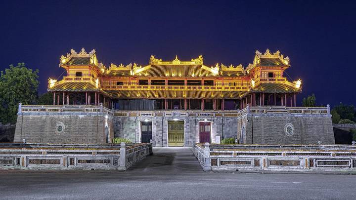 Nighttime view of illuminated Imperial City gate in Hue reflecting classical Vietnamese architecture