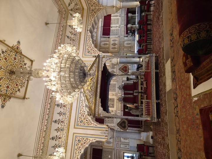 Opulent palace hall with grand chandeliers, silver throne and ornate decor