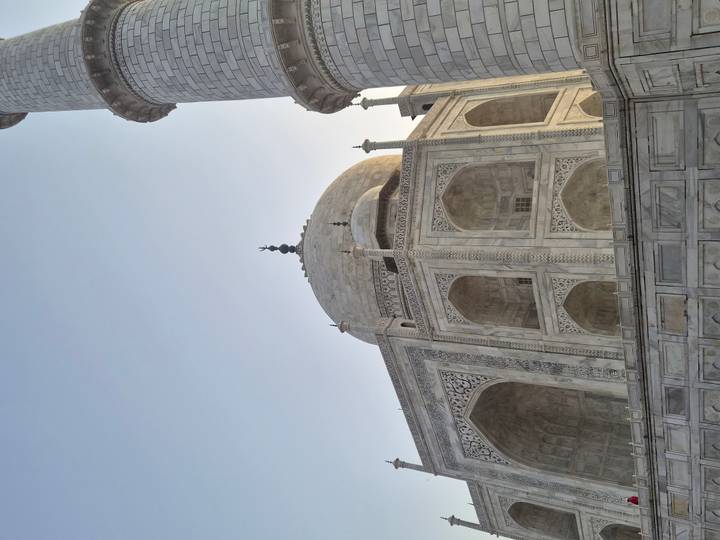 Close-up architectural detail of the white marble Taj Mahal at dawn