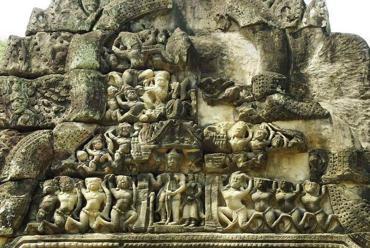 Detailed bas-relief carvings depicting mythological scenes on an ancient Khmer temple wall.