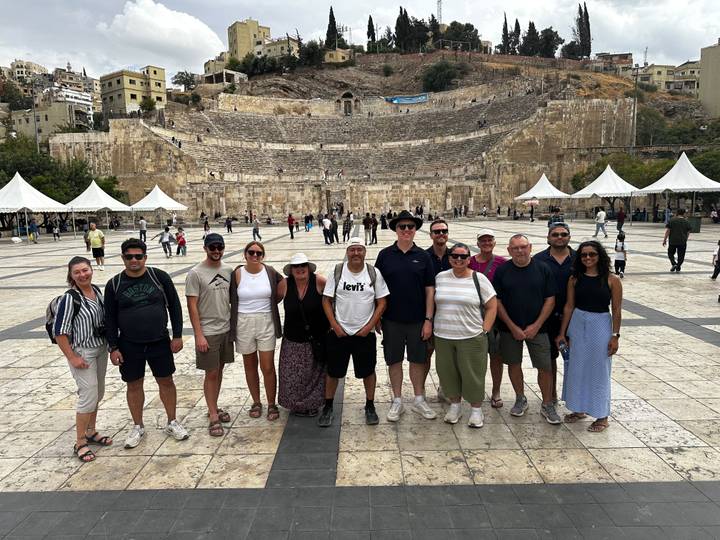 Tour group standing in front of the ancient Roman Amphitheatre in the heart of Amman.