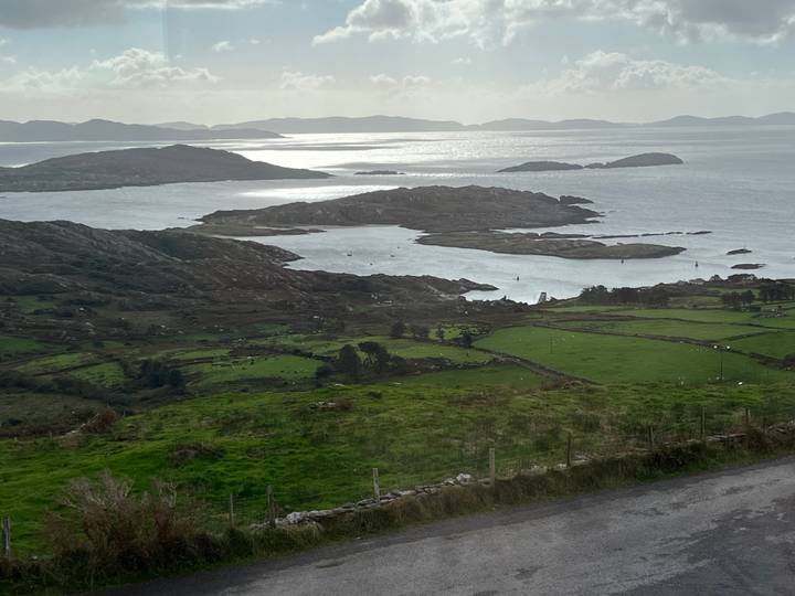 Sweeping coastal panorama of rocky peninsulas, stone-walled fields and shimmering Atlantic waters.