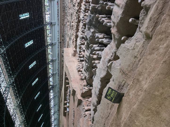 Expansive hall housing rows of Terracotta Warriors still in situ beneath a vast steel roof.