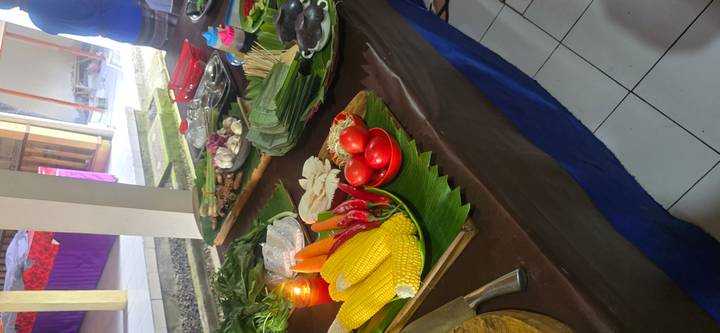 An array of fresh vegetables, spices and cooking tools set up for a Balinese cooking class.