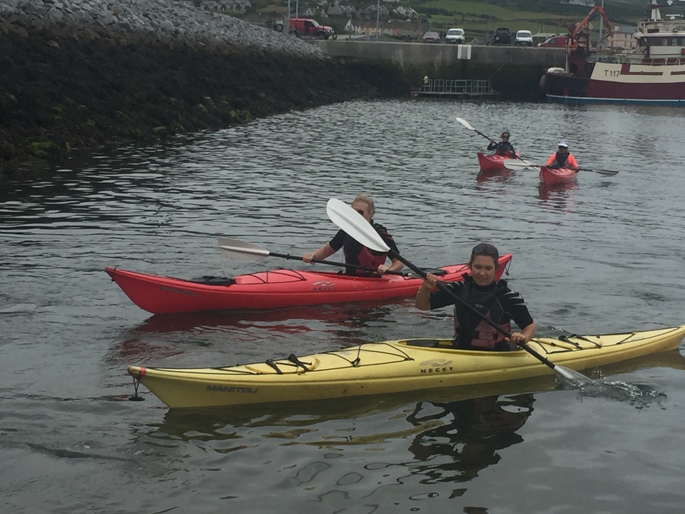 Des personnes font du kayak dans un plan d'eau calme.
