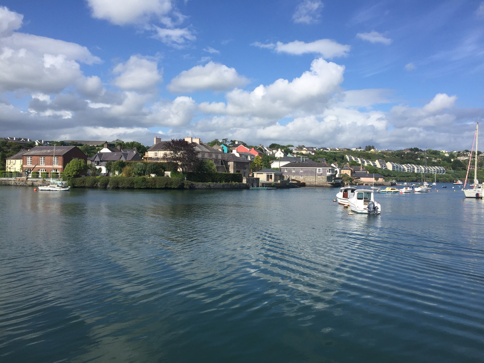 Une scène de port paisible avec des bateaux et des maisons.