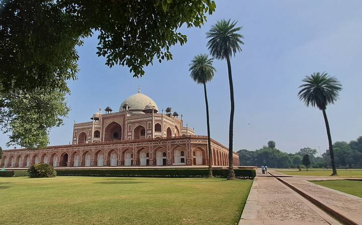 Elegant Humayun’s Tomb set amid manicured lawns and tall palms under clear blue skies