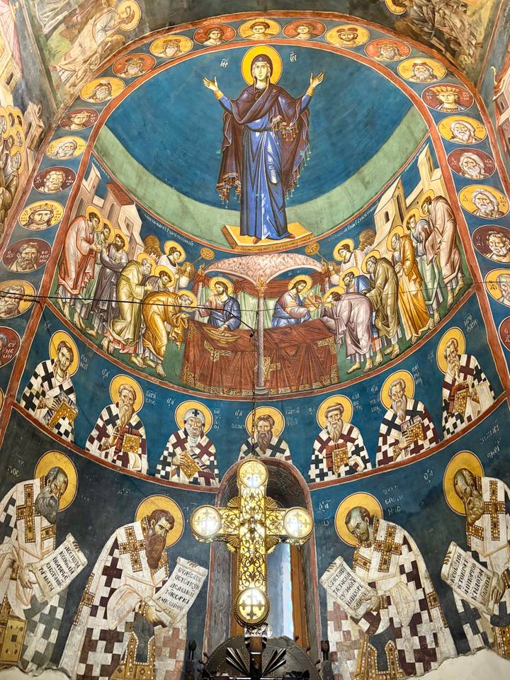 Circular ceiling fresco in rich colors with concentric rings of saints and biblical storytelling.
