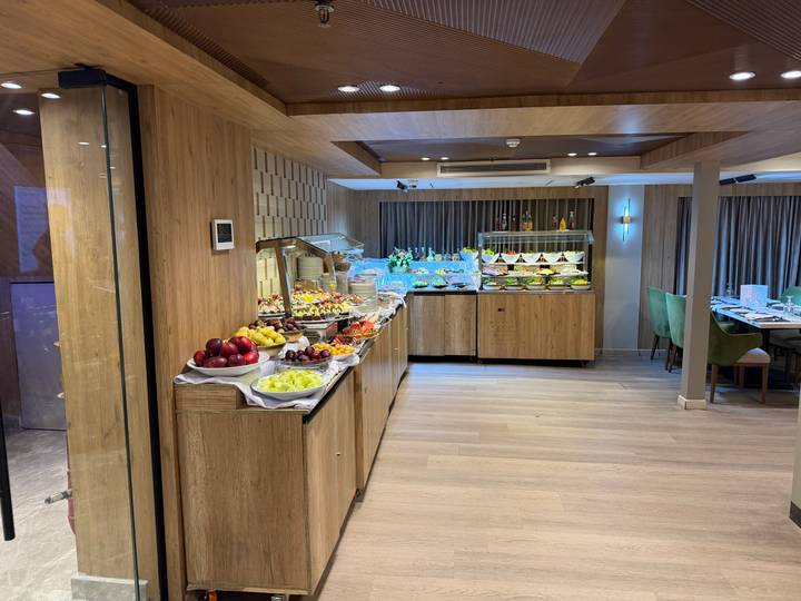 Well-stocked buffet line with colorful fruit and desserts aboard a Nile cruise ship restaurant.