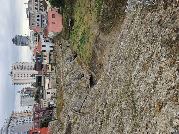 Ruins of ancient arena slope amid modern city buildings in Durres.