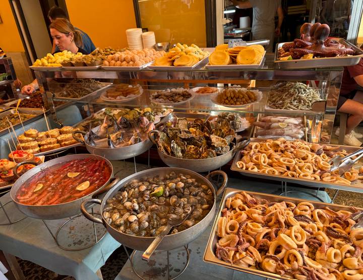 Vibrant array of fresh seafood, shellfish and fried delicacies at a bustling Sicilian food stall
