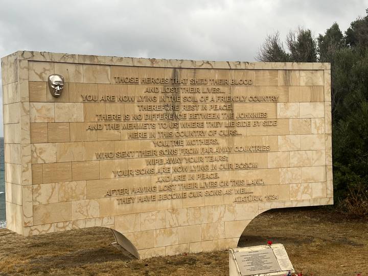 Stone memorial wall engraved with Atatürk's famous tribute at Gallipoli battlefield.