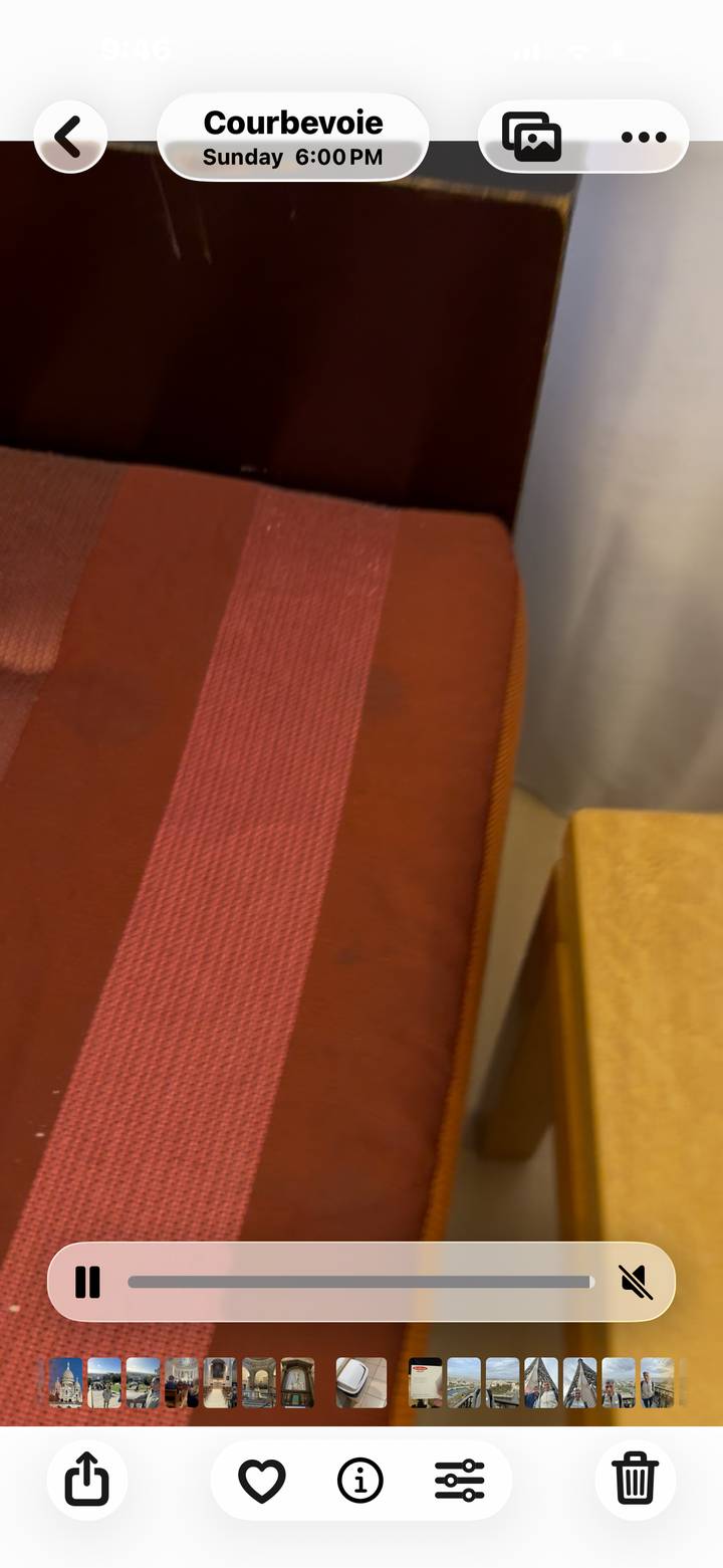 Blurry close-up of a red and brown fabric seat.