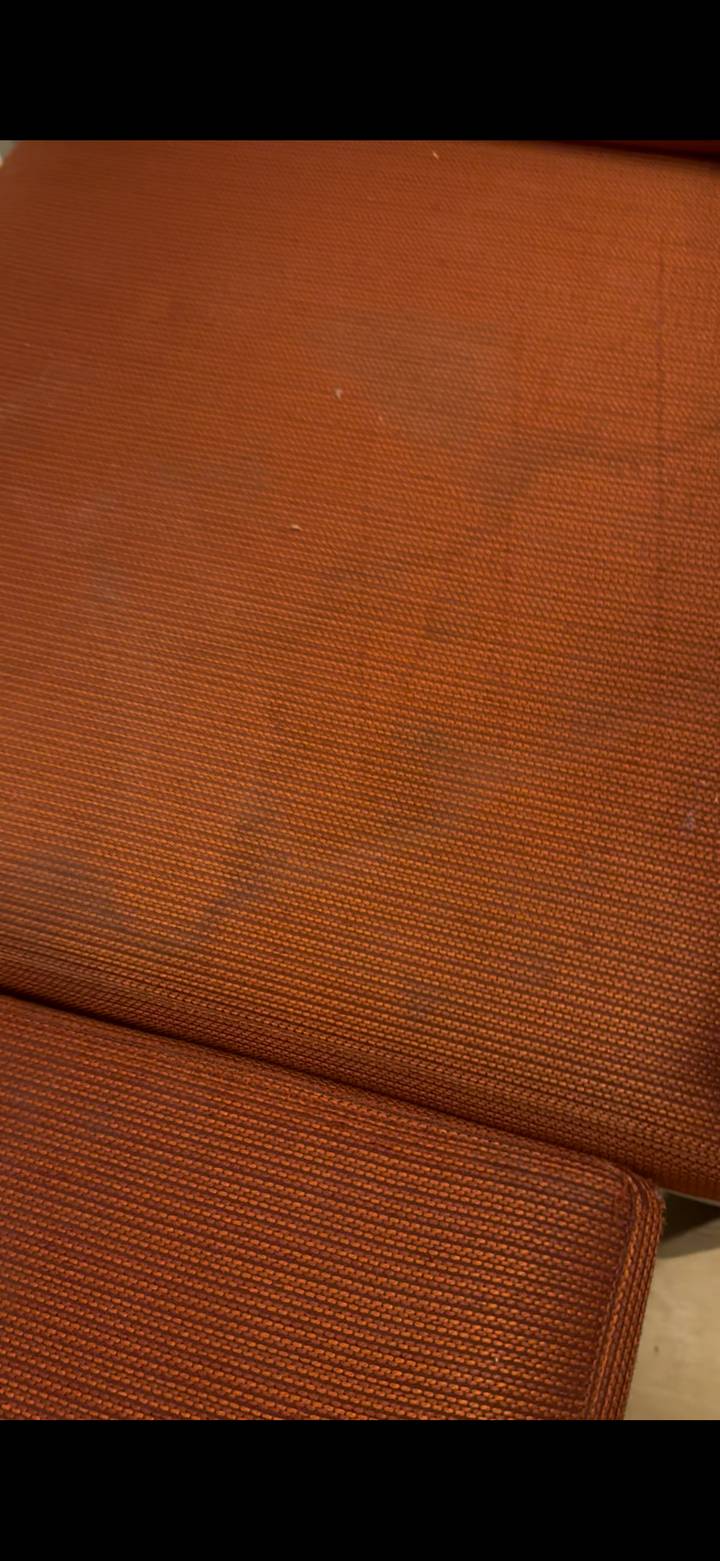 Textured brown fabric surface photographed close-up.