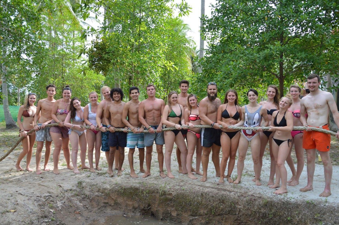 Group holding a rope during an outdoor activity.