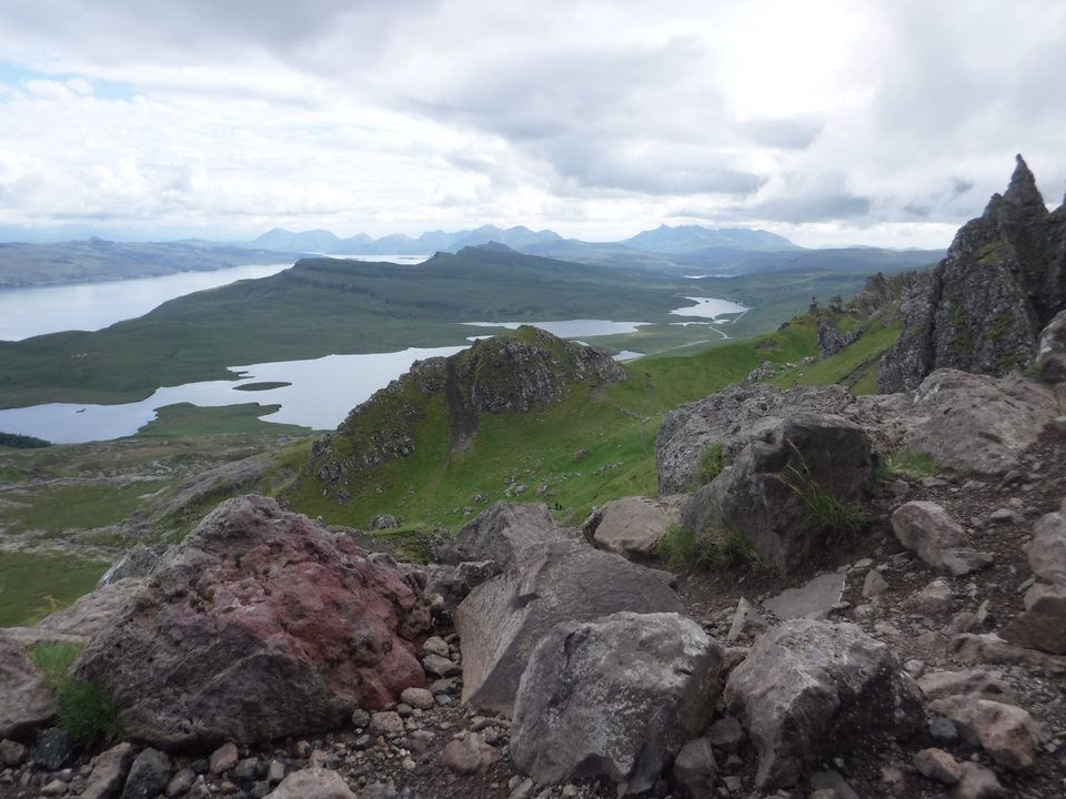 A sweeping view of a mountainous valley with lakes.