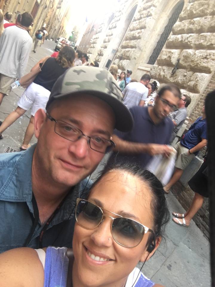 Deux personnes prenant un selfie dans une rue animée de la ville.