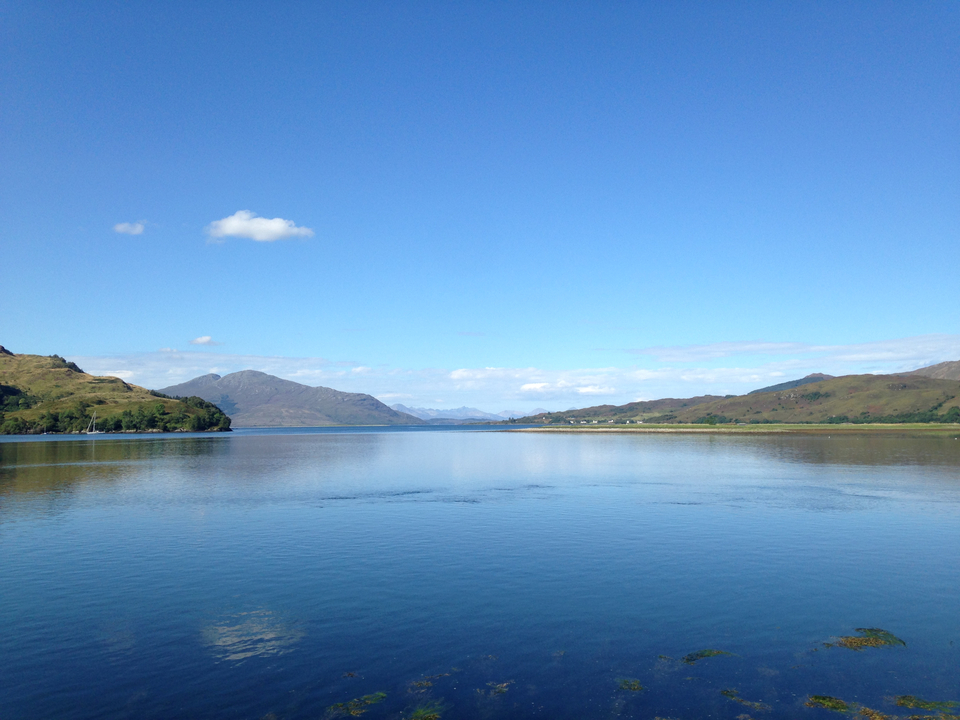 Serene view of a lake with mountains in the background.