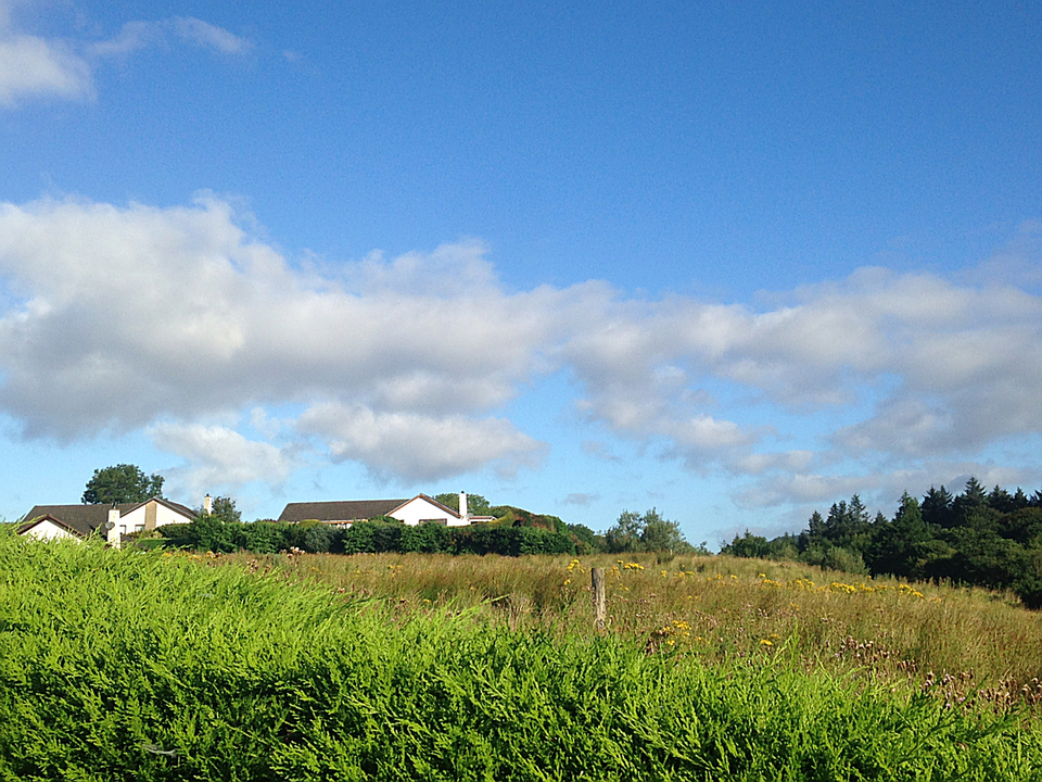 Small houses on a hill under a clear blue sky.