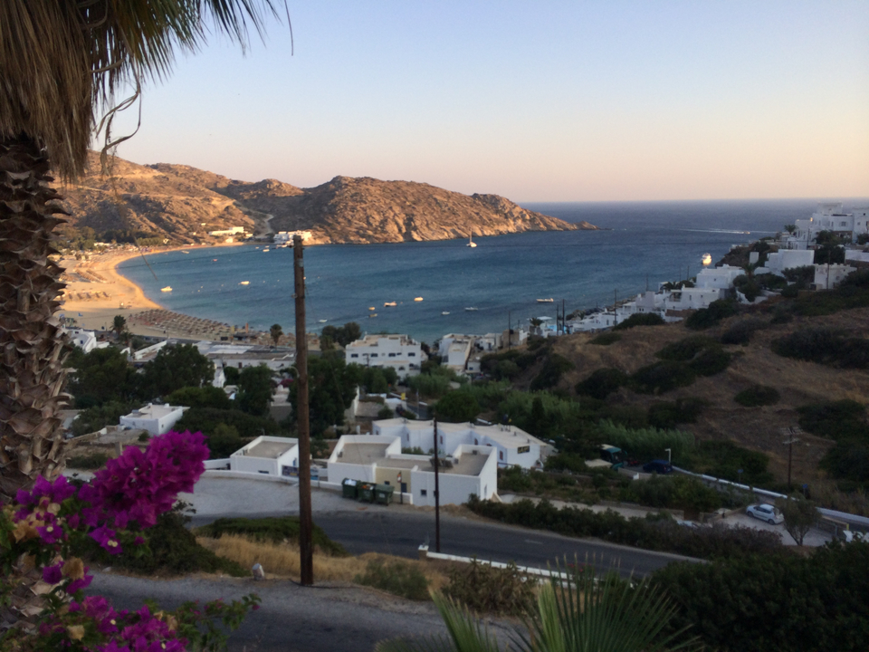 Coastal landscape with white buildings and mountains.