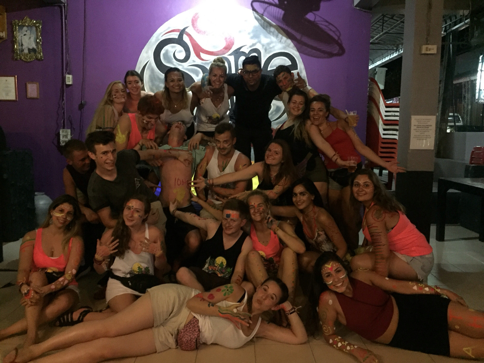 Group with face paint posing energetically indoors.