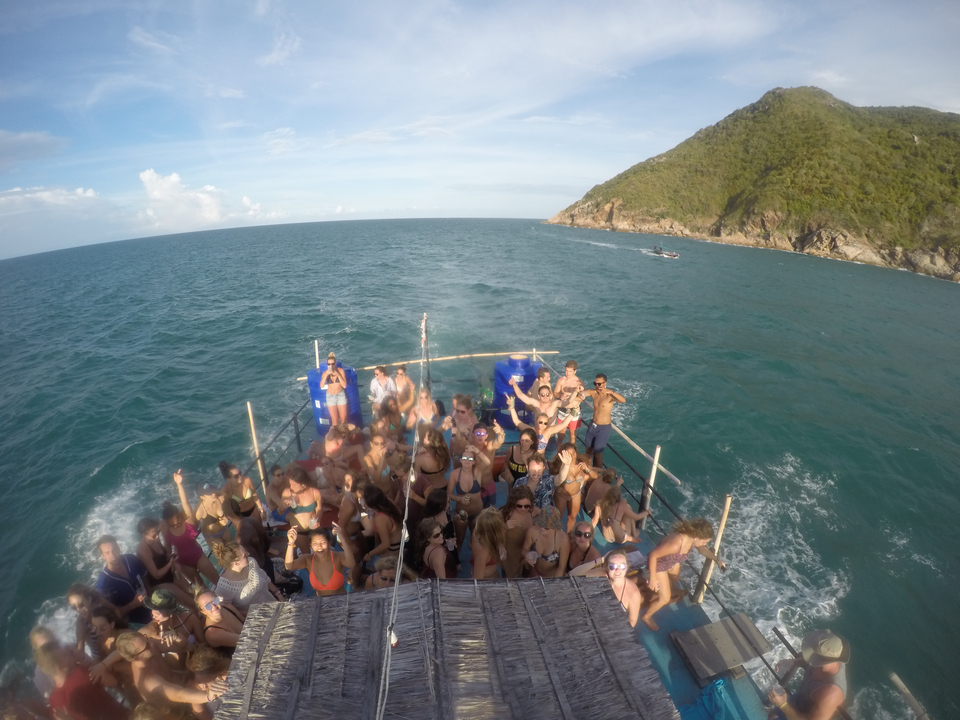 Group of people partying on a boat at sea.