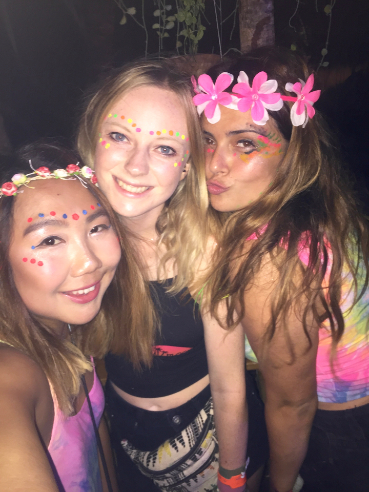 Three young women with festive face paint.
